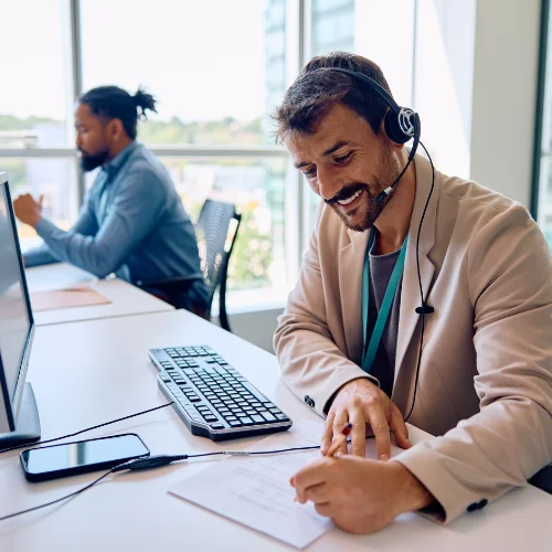 Call center agent taking notes on tech support call
