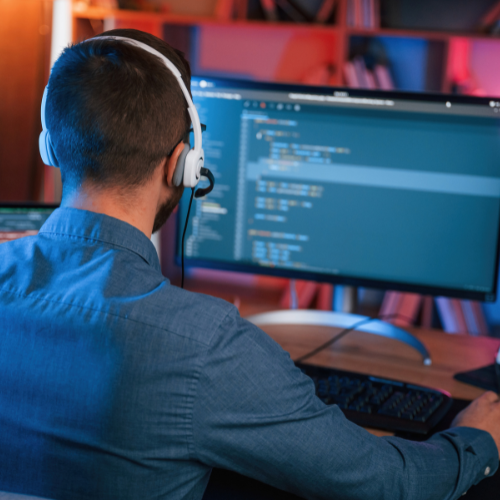 Man wearing headset works on computer