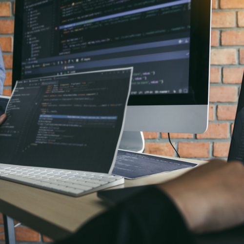 Asian man working code program developer computer web development working design software on desk in office.